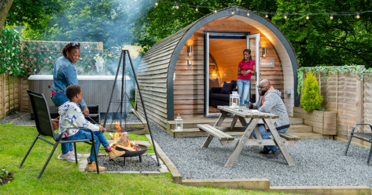 Family enjoying a BBQ at West Hall Glamping pods.